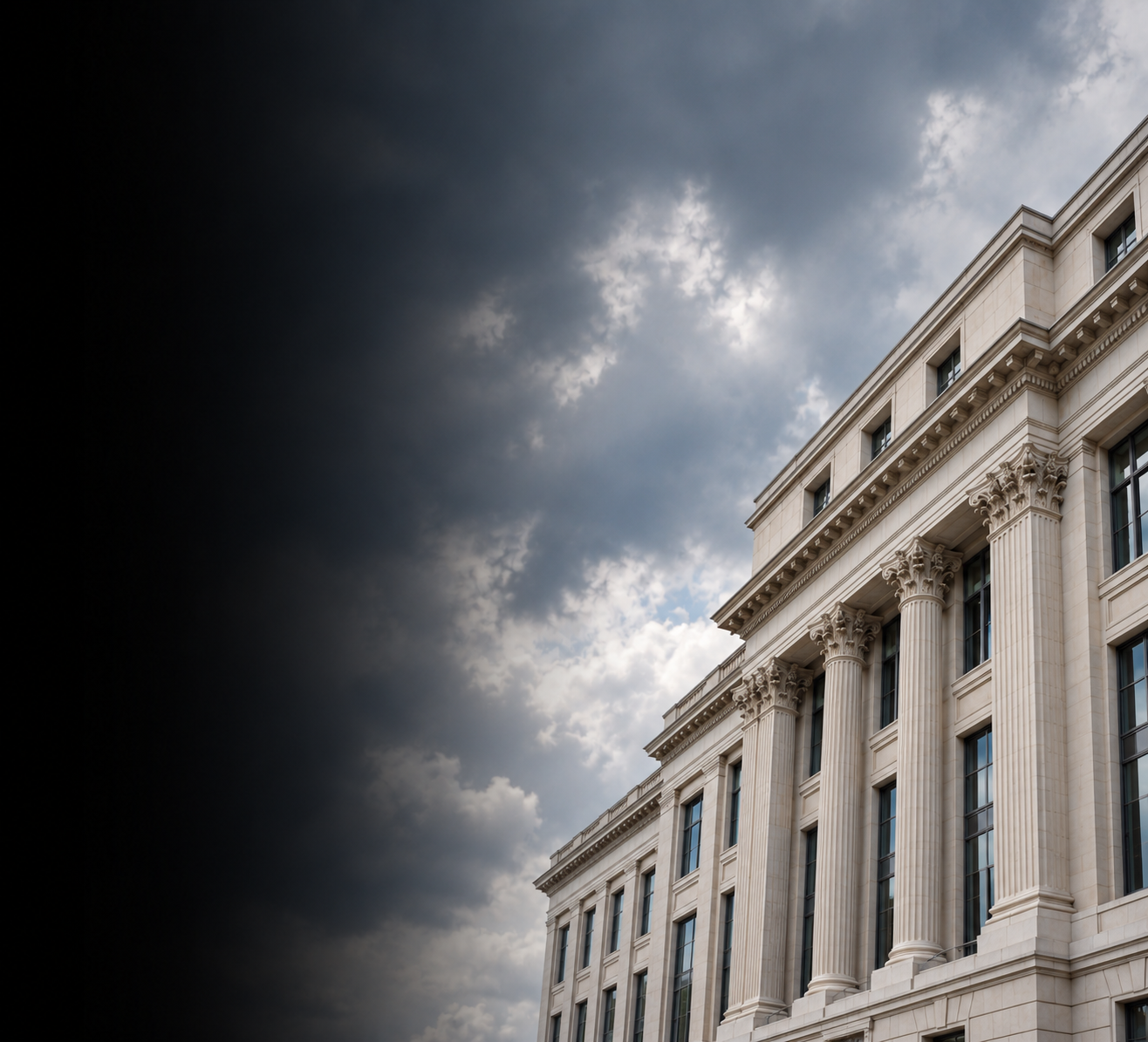 Limestone office building beneath a cloudy sky